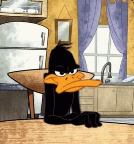 Cartoon of Daffy Duck sitting at a kitchen table
